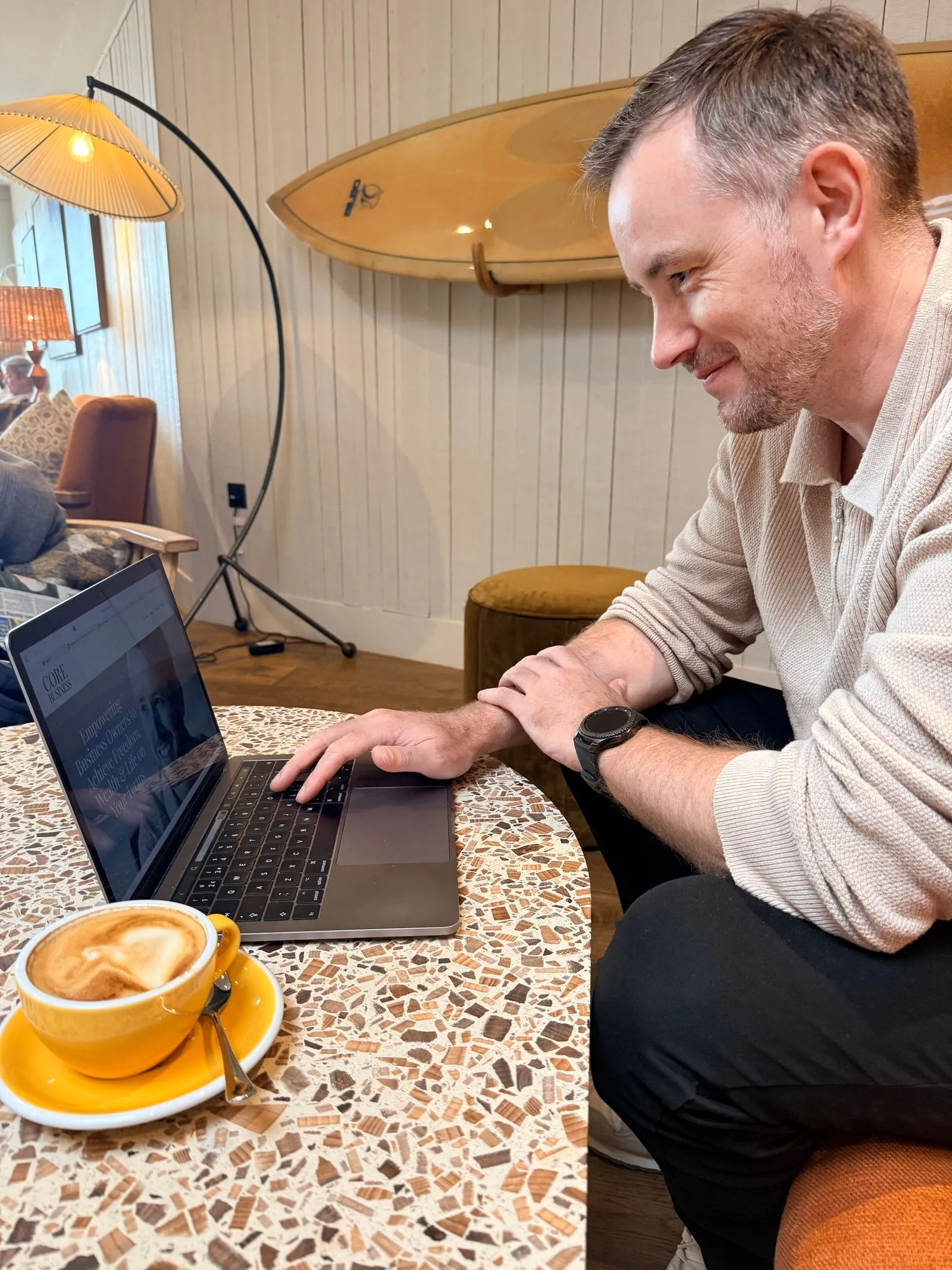 Nick Thorpe working from a café in Cornwall